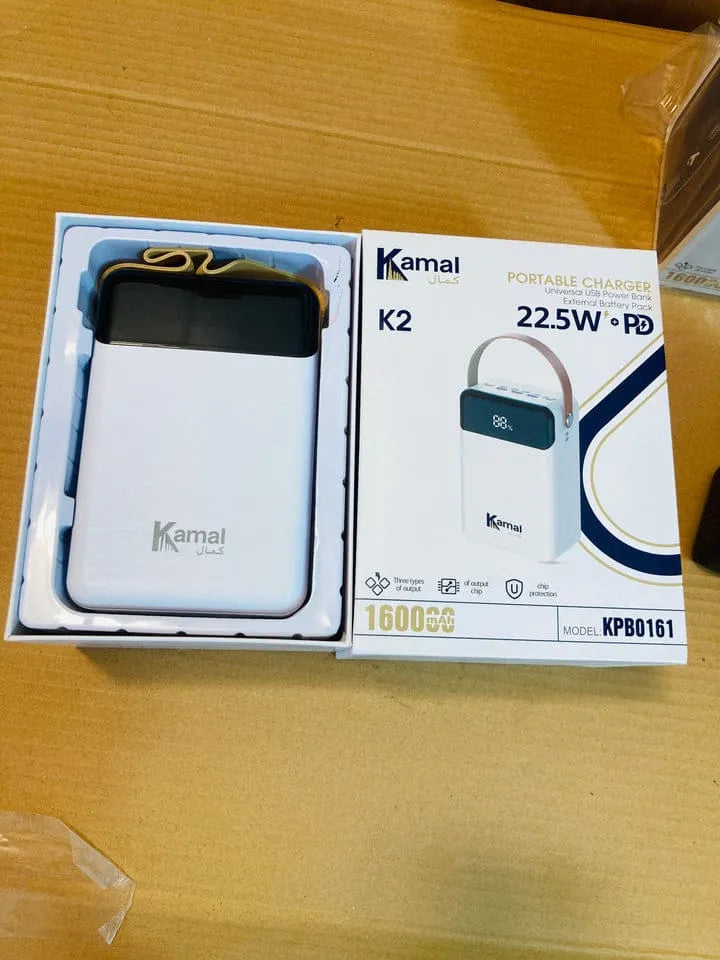 Kamal K2 portable charger in open packaging on a wooden surface