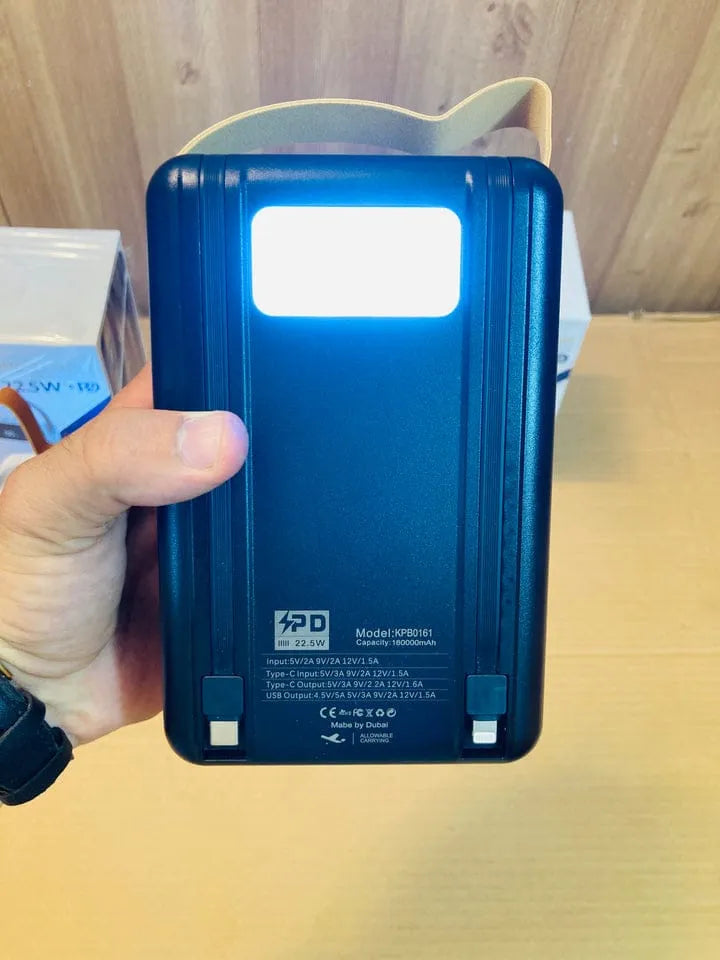Blue portable device with a screen held by a hand on a wooden surface